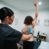 Physiotherapist assessing shoulder movement in a patient with frozen shoulder at Head2Toe Physiotherapy