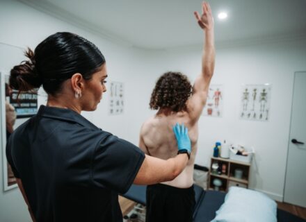 Physiotherapist assessing shoulder movement in a patient with frozen shoulder at Head2Toe Physiotherapy